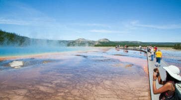 Visitors Stop Along The Boardwalk To Take Photos Of The Grand Prismatic Spring At The Midway Geyser Basin In Yellowstone National Park