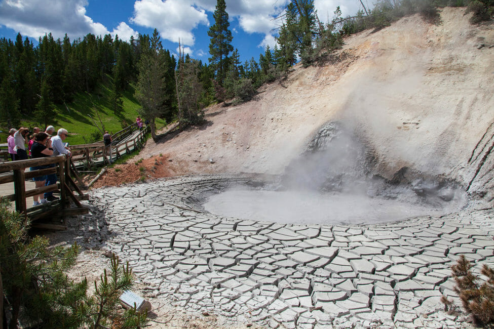 Tourists Pause On The Boardwalk To View The Mud Volcano As It Bubbles With Superheated Water Mixed With Mineral Deposits