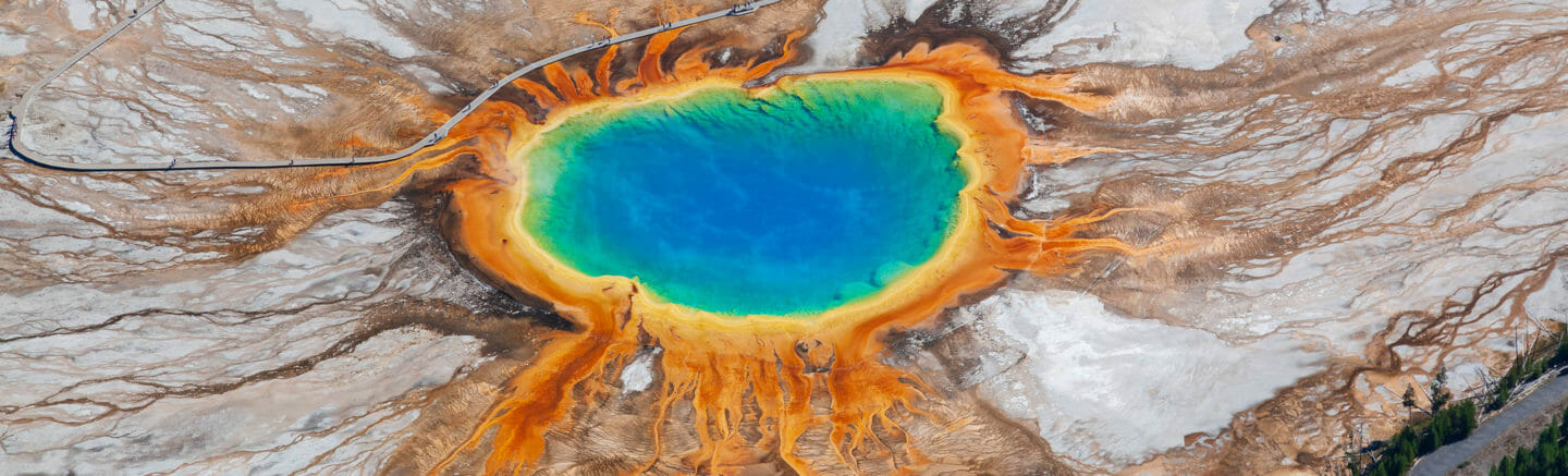 An Aerial View Of The Grand Prismatic Spring In Yellowstone National Park Shows The Vibrant Rainbow Hues Of The Thermophiles Living In The Water
