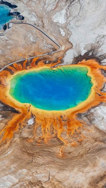 An Aerial View Of The Grand Prismatic Spring In Yellowstone National Park Shows The Vibrant Rainbow Hues Of The Thermophiles Living In The Water