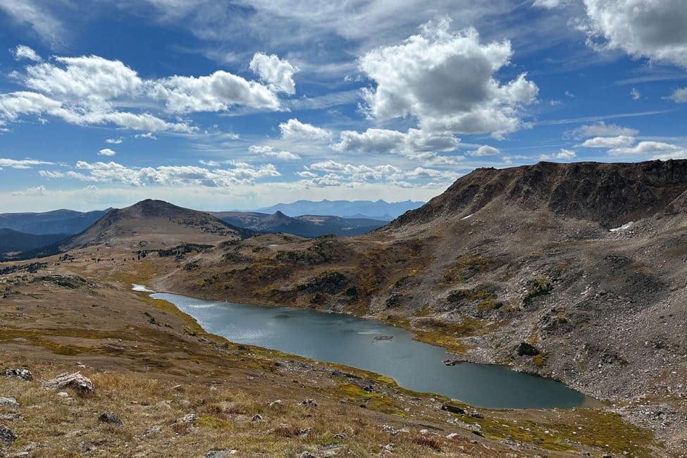 Clear skies over a pristine alpine lake can be seen from the Beartooth Pass