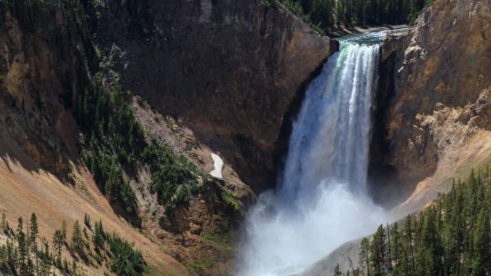 The Lower Falls Of The Yellowstone River Pours Into The Grand Canyon Of The Yellowstone Creating A Rainbow In The Rising Mist