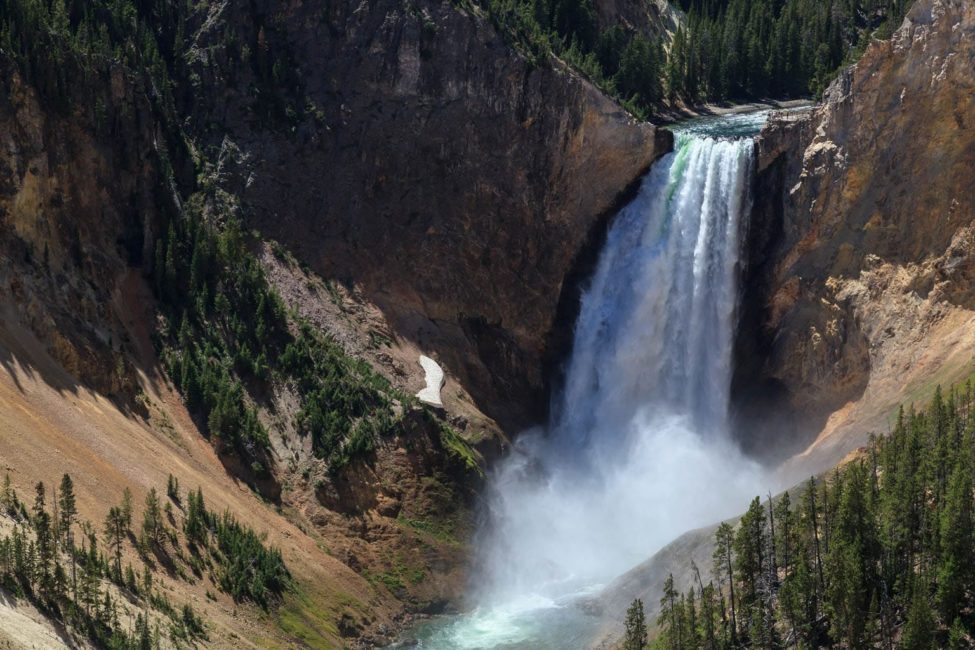The Lower Falls Of The Yellowstone River Pours Into The Grand Canyon Of The Yellowstone Creating A Rainbow In The Rising Mist
