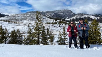 Guests Pose On Snowshoes For A Snapshot During A Big Sky Adventure Tour In Montana With Yellowstone Safari Company