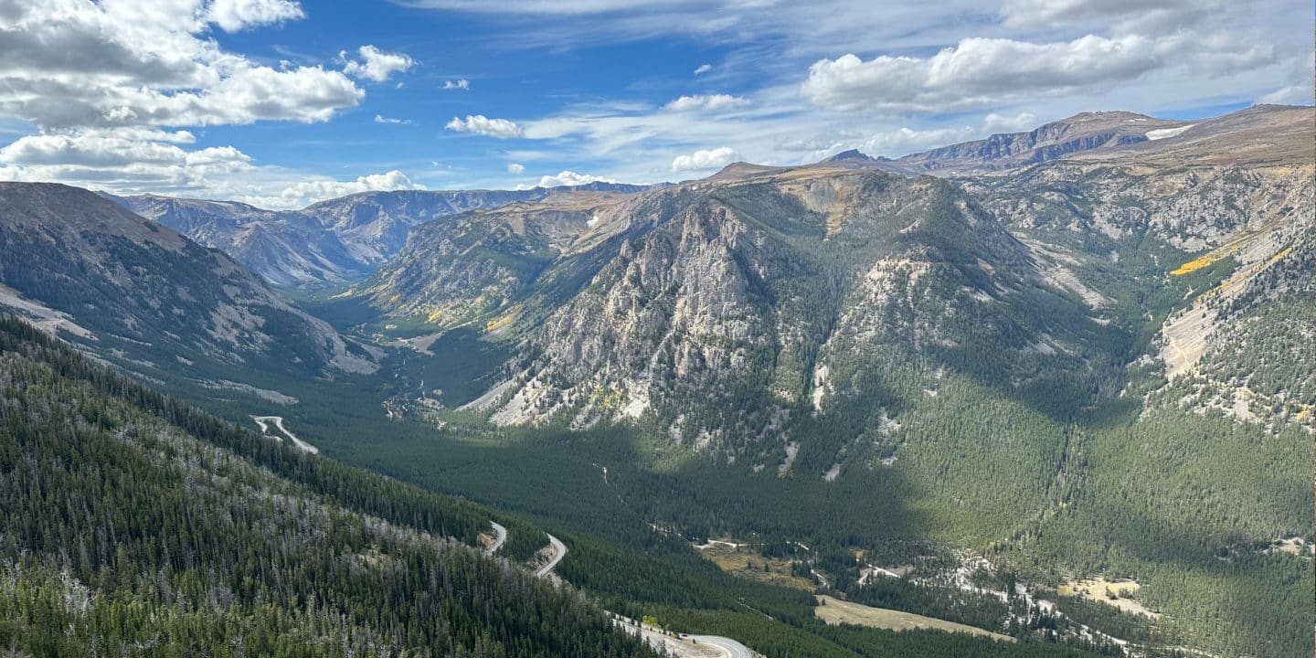 An overlook of the famous Beartooth Highway showing clear skies and rugged mountains