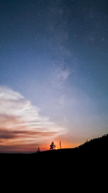 Stars Appear Above A Ridgeline In Yellowstone National Park As The Sun Sets And The Night Sky Becomes Visible